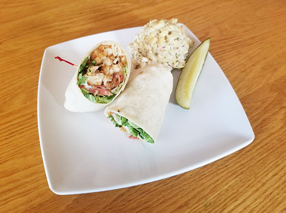 Wrap with chicken, tomato, lettuce, ranch dressing, pickle and macaroni salad